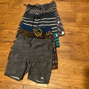 Size 24 boys shorts- 3 boardshorts, 1 walking shorts.